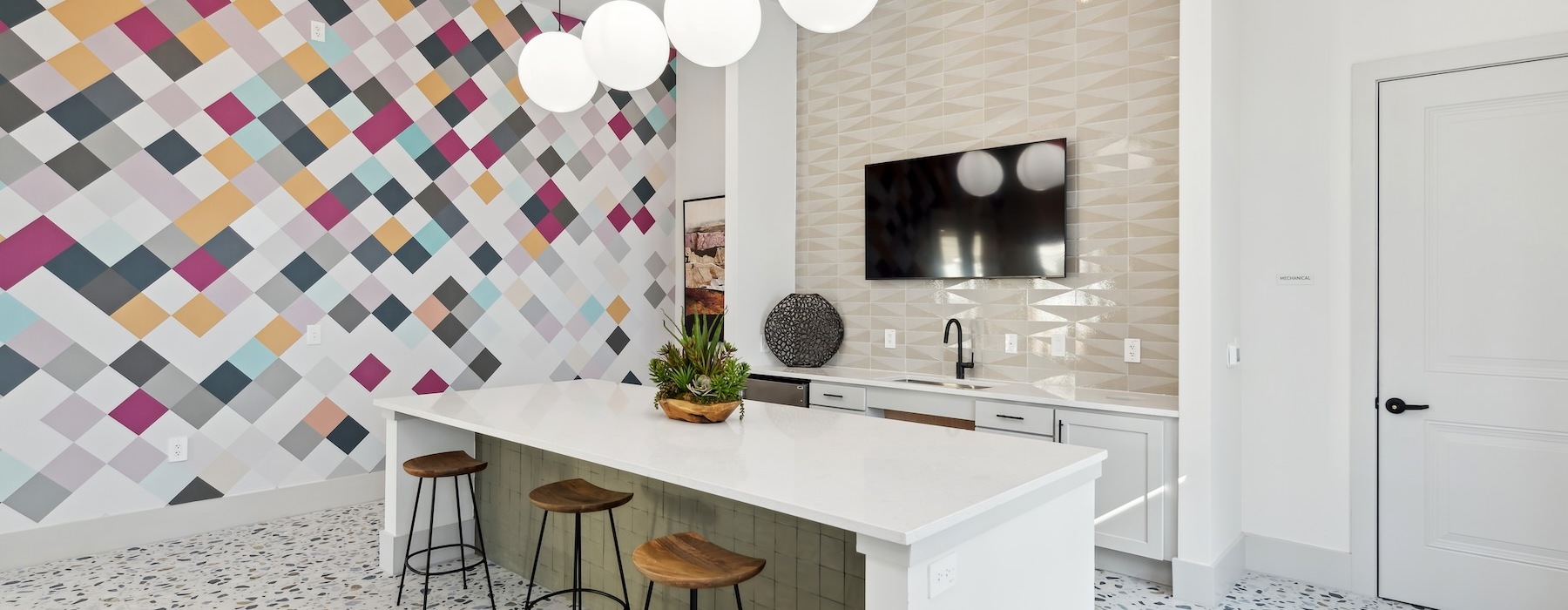 a kitchen with a counter and stools