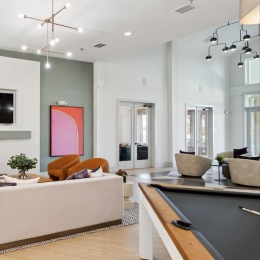a clubroom with a pool table and a couch