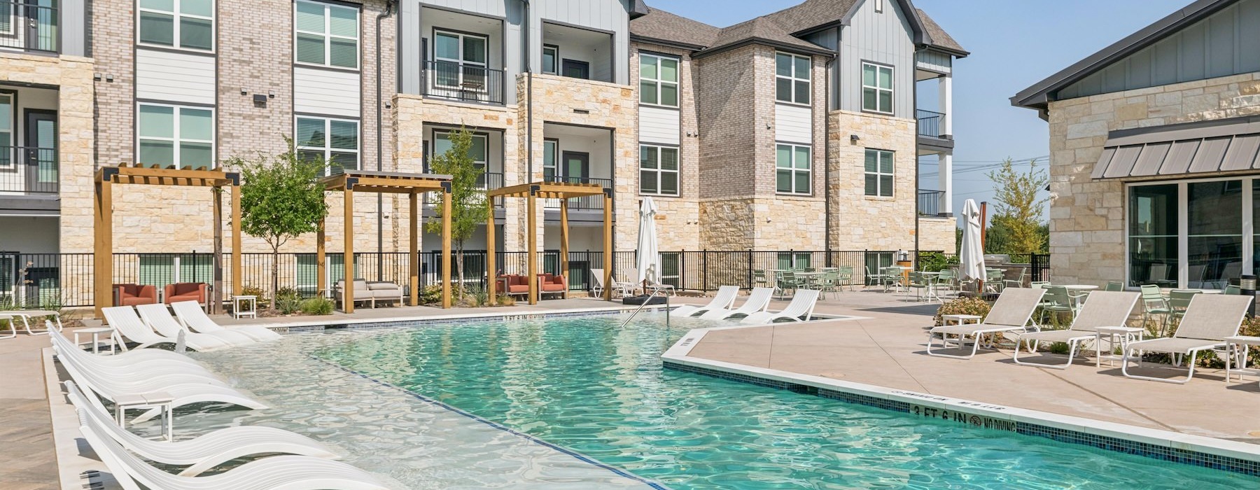 a swimming pool in front of a large building