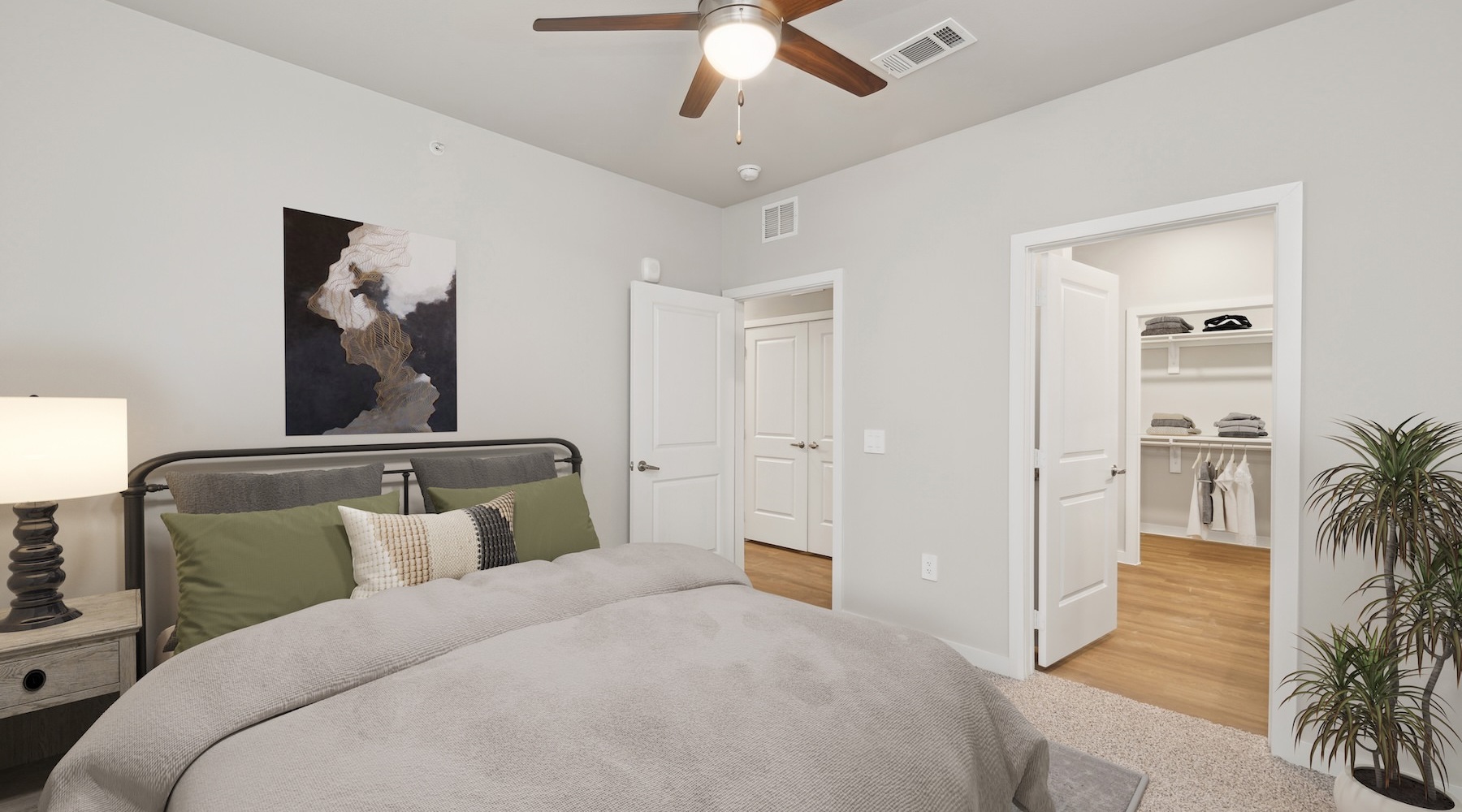 a bedroom with a bed and a fan