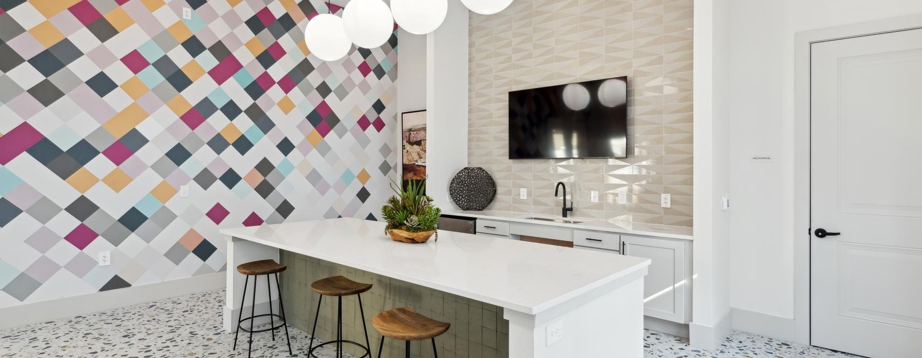 a kitchen with a counter and stools